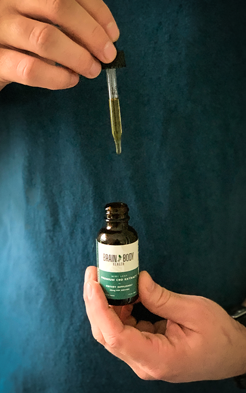 A bottle of hemp oil being extracted through a dropper.